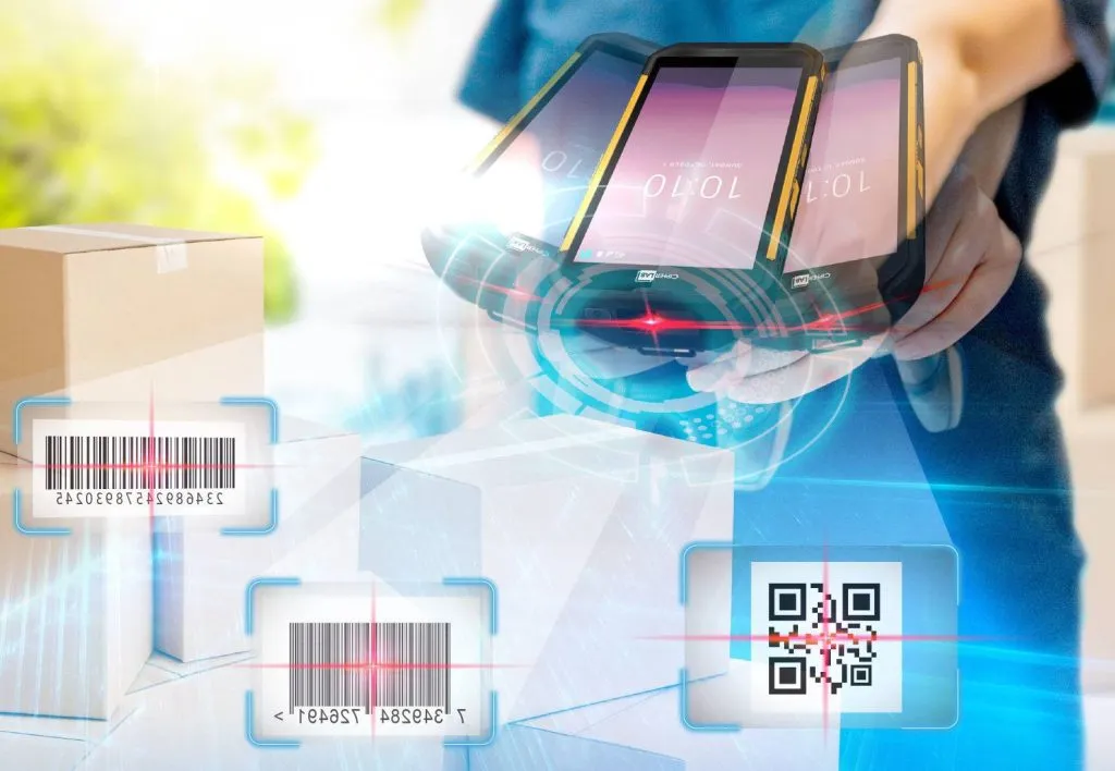 A person holds multiple smartphones scanning barcodes and QR codes on shipping boxes in a bright, digital environment.